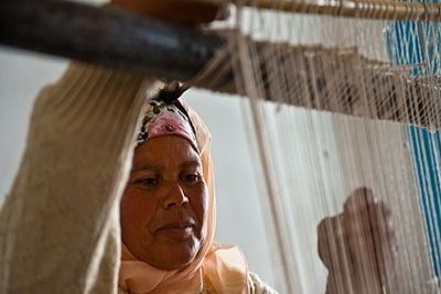 Woman in training center for production of local handicrafts.